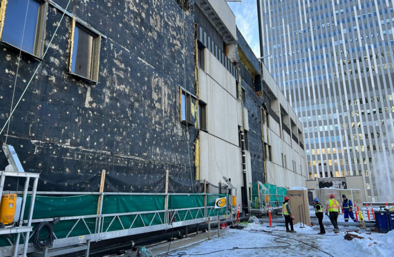 Exterior panels have been removed from Glenbow's building, exposing the original weatherproofing underneath