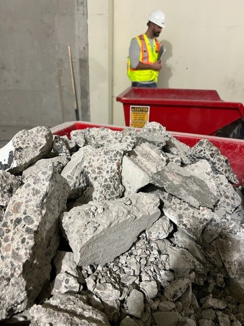 A pile of concrete rubble from cutting between the floors.